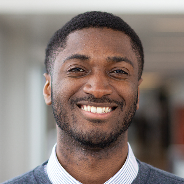 Alfred Burgesson professional headshot, smiling to camera