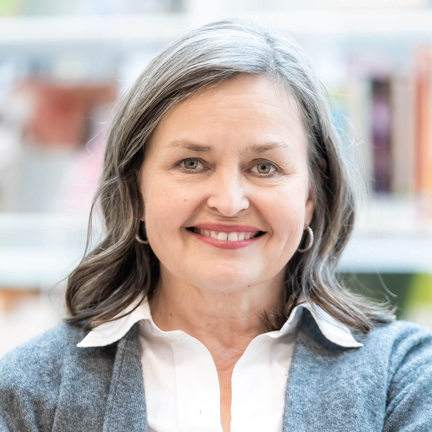 Professional headshot of Asa smiling to camera