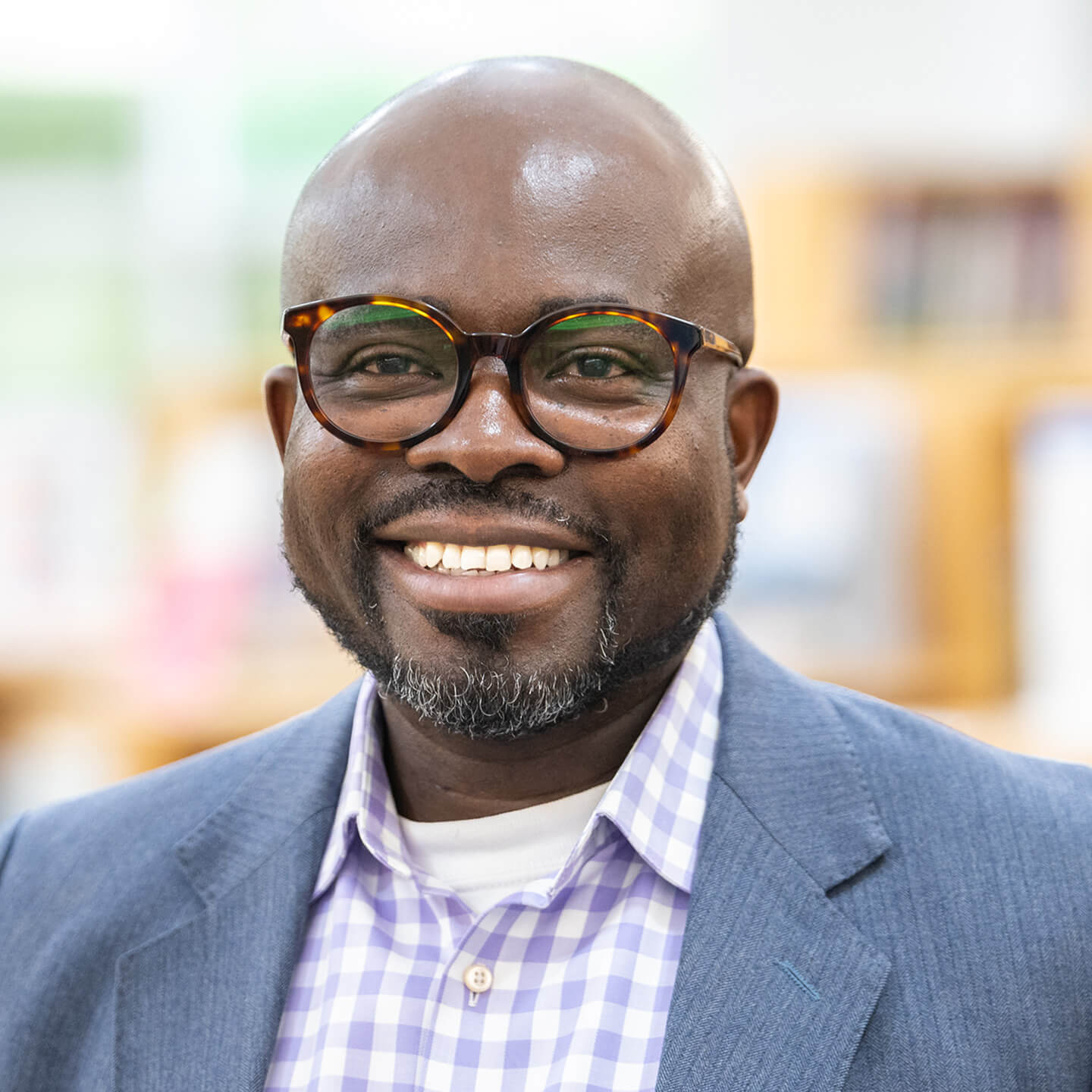 Ayo Aladejebi professional headshot, smiling to camera